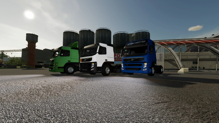 fs22-mods,  Three Volvo FM13 trucks in green, white, and blue parked at a farm in FS22 mod.