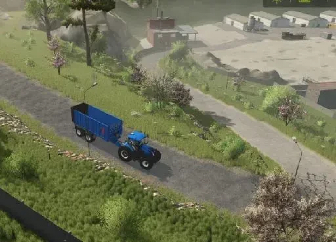 A tractor with a blue trailer on a scenic road in FS25 mod AutoDrive Oltenburg Map.