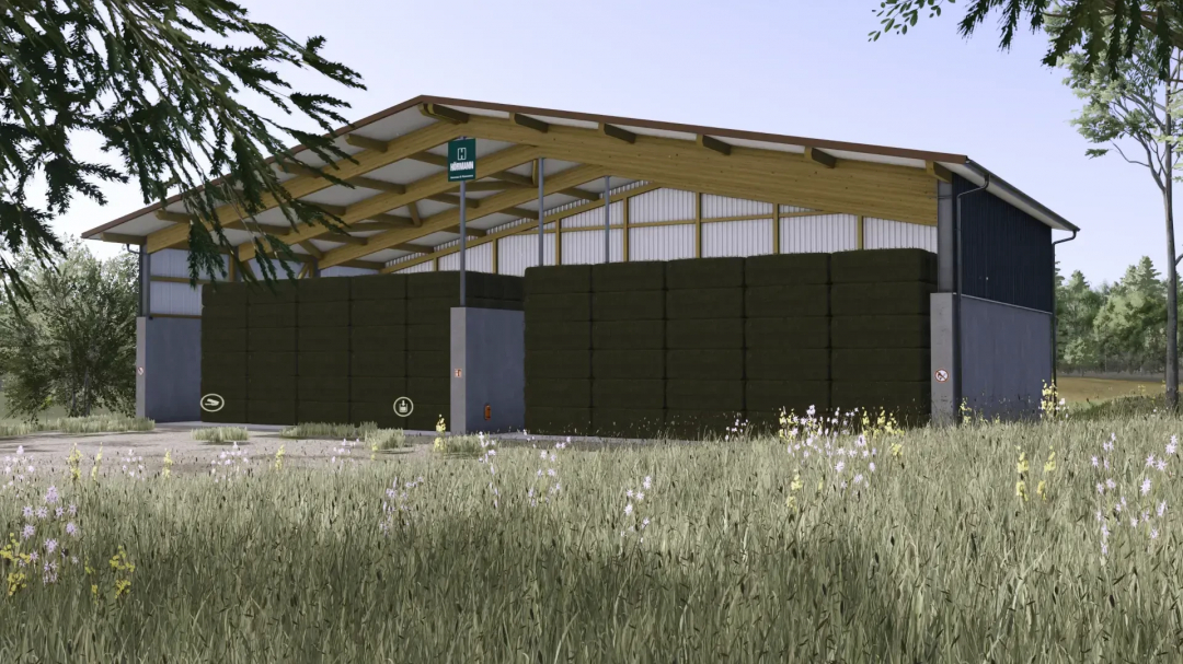 Bale Storage XXL mod in FS25, showcasing a large barn with stacked bales surrounded by grass and trees.