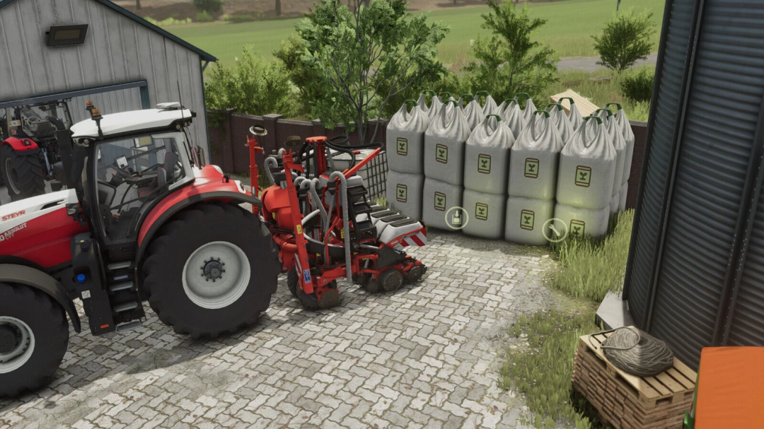 FS25 mod BigBag Tank v1.0.0.0 showing a tractor next to large fertilizer bags in Farming Simulator 25