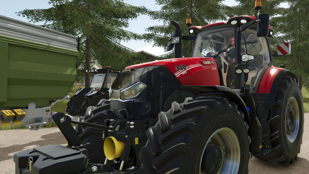 Case IH Optum tractor mod in FS25 with red exterior, parked near a green trailer in a forest setting.