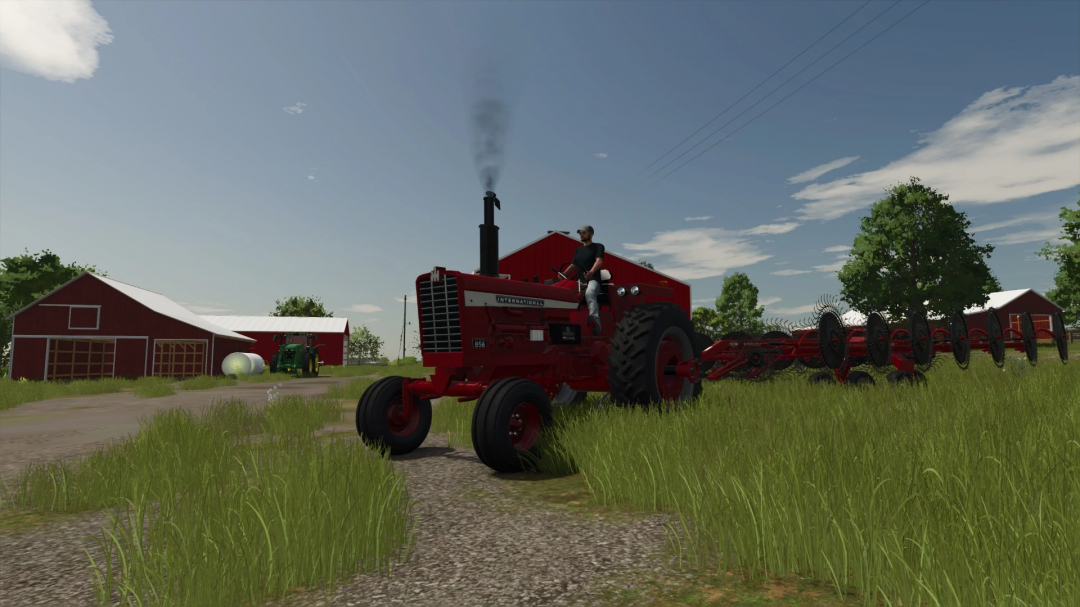 International 856 tractor mod in FS25, Farming Simulator 25, driving on a farm path with hay equipment attached.