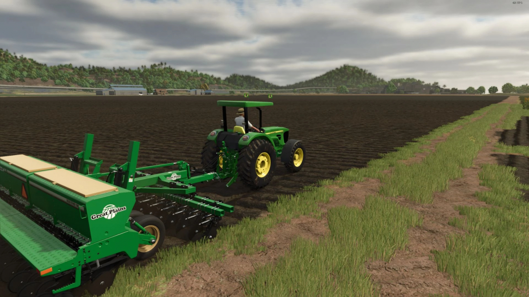 FS25 mod John Deere 50E Series v1.0.0.0 cultivating a field in Farming Simulator 25.