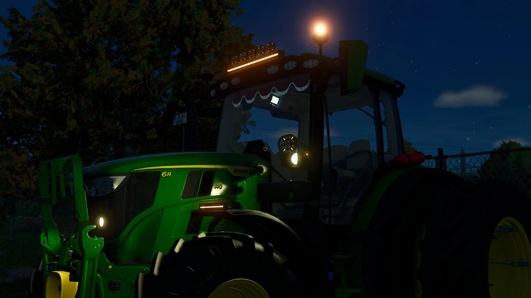 John Deere 6R Small Frame tractor at night in FS25 mod.