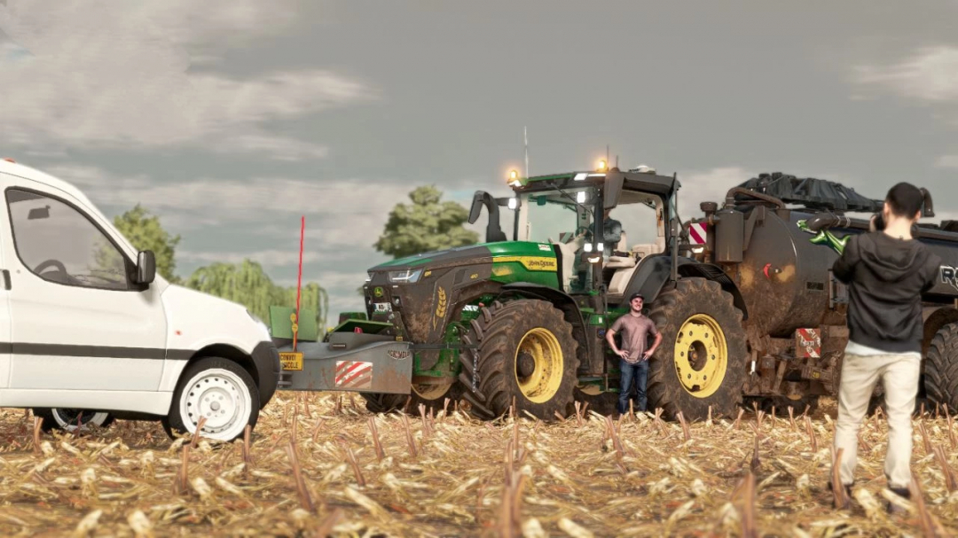 John Deere 8R 420 tractor in a field with people, featured in FS22 mods.