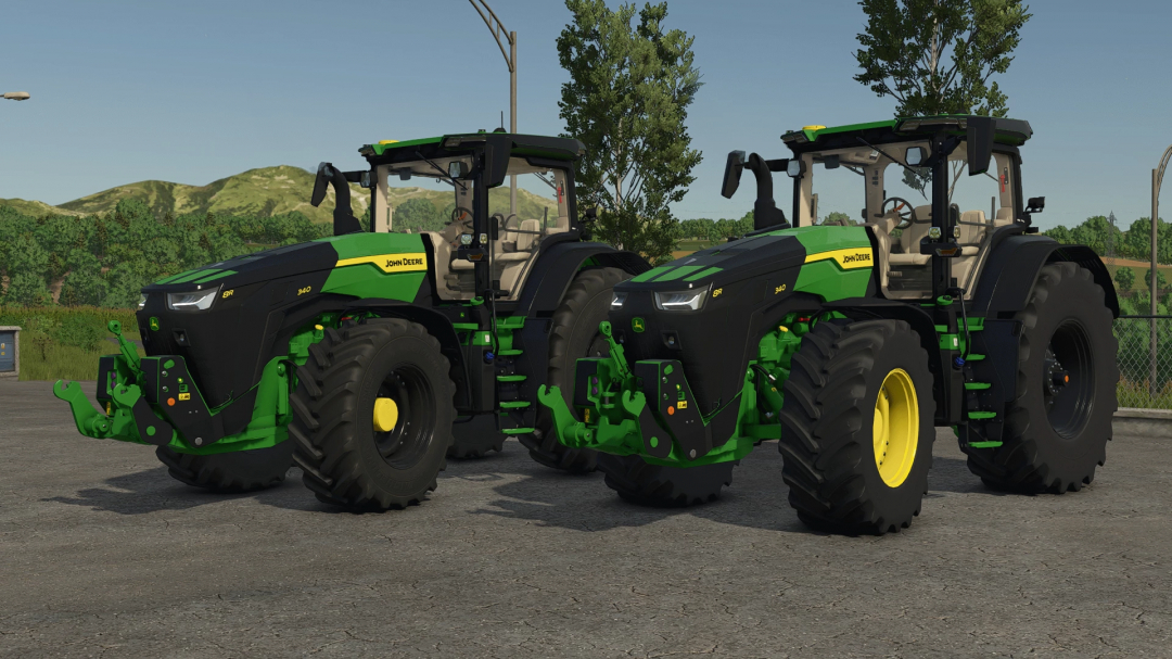 Two John Deere 8R Wirtgen Group Edition tractors in FS25 mod, parked on asphalt with greenery background.