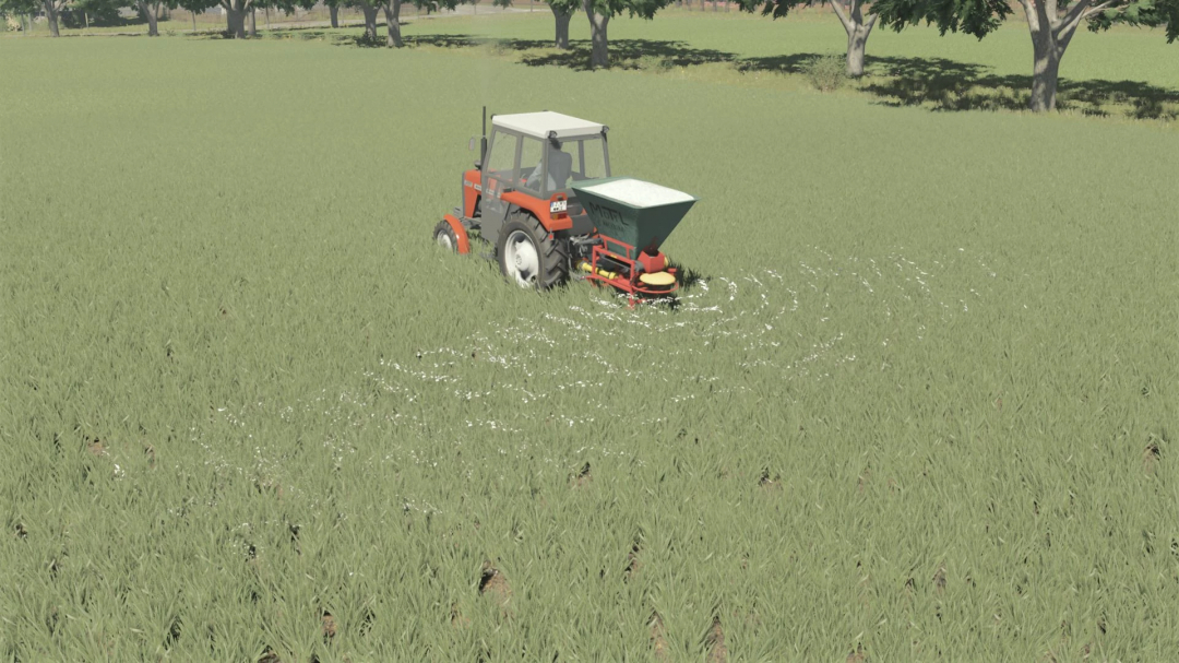 FS25 mods: POM Motyl NO13 tractor spreading fertilizer in a green field.