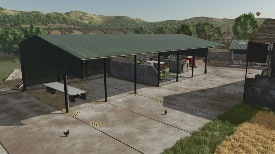 Pallegney Buildings Pack in FS25 features a large barn with open bays, machinery, and landscape view.