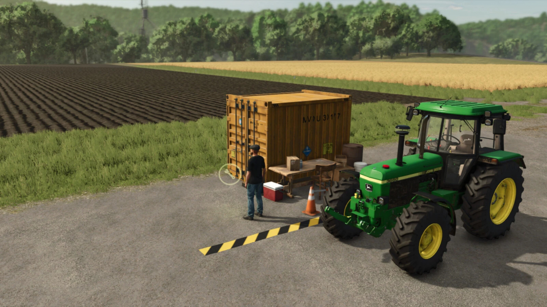 FS25 mod Small Container Workshop v1.0.0.0 with a tractor near a yellow container workshop setup in a field.