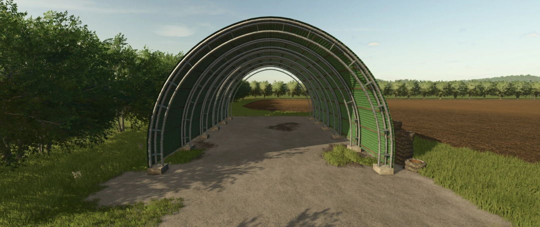 FS25 mod image showing a green arched farm structure near fields and trees in The small European town mod.