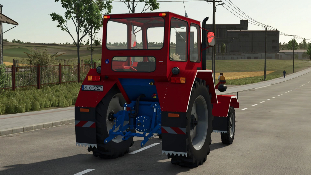 Rear view of red U650M tractor mod in FS25 on a road, showcasing design details.