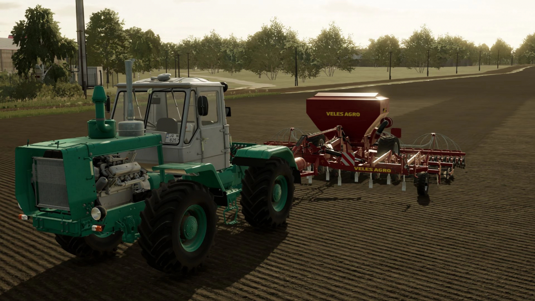 FS22 mod Veles Agro 6M v1.0.0.0 in Farming Simulator 22, showing a green tractor pulling red agricultural equipment on a farm.