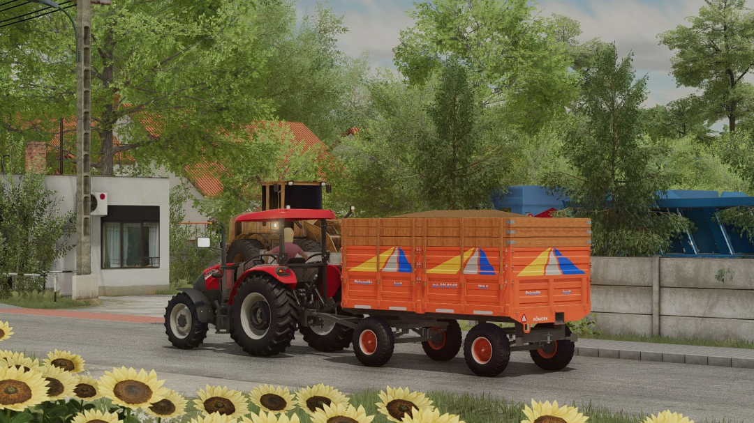 FS22 mods image showcasing a red Case IH JXE Series tractor with an orange trailer in a rural setting from Farming Simulator 22.