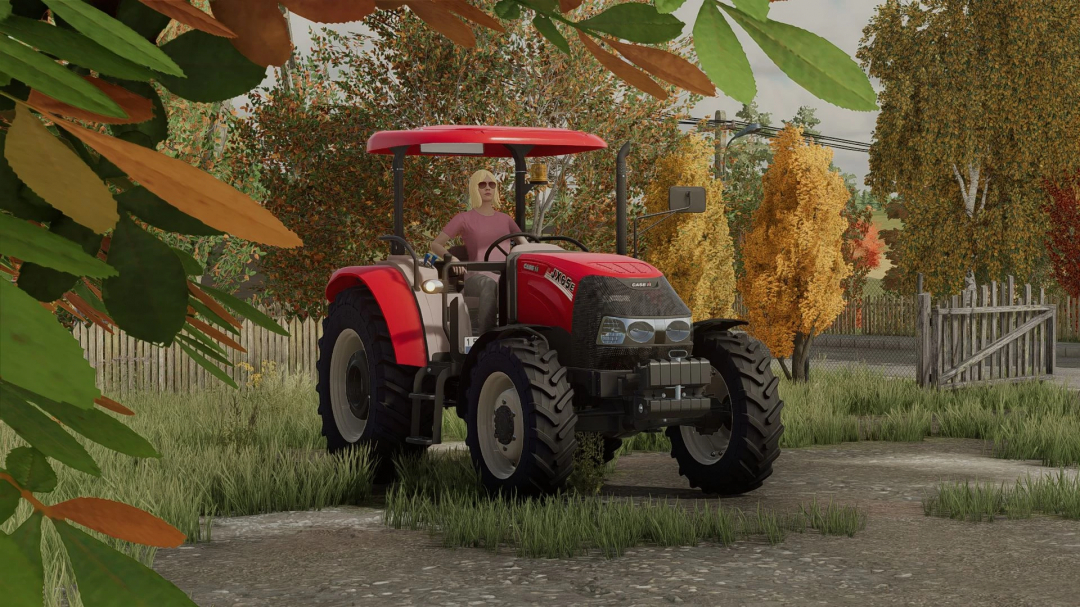 Case IH JXE Series tractor mod in FS22, featuring a farmer driving it amidst an autumn landscape.