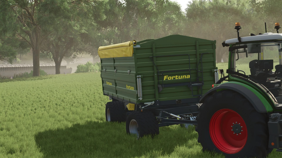 FS25 mod Fortuna K180 trailer attached to a tractor in a lush green field.