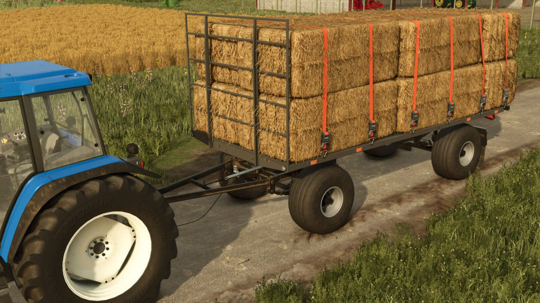 FS25 mod HW80 Wood Trailer loaded with hay bales, attached to a blue tractor on a farm path.