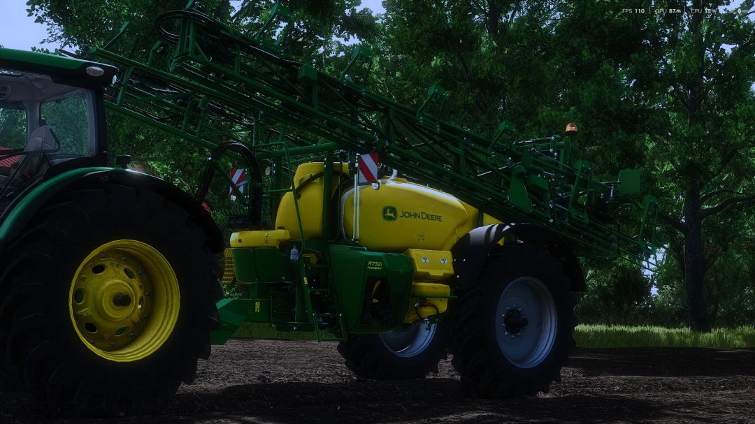 John Deere R700i sprayer mod in FS25 game, showcasing green and yellow equipment attached to a tractor amidst trees.