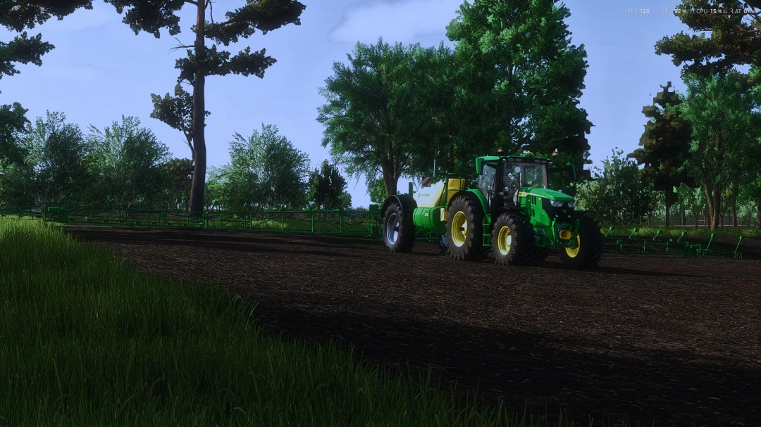 John Deere R700i mod in FS25, depicted on a farm field with trees in the background.