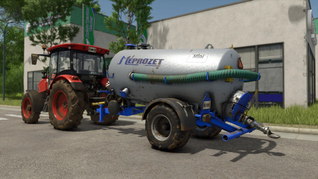 FS25 mod Meprozet PN-50 v1.0.0.0; a red tractor pulling a Meprozet PN-50 tank near a building in Farming Simulator 25.