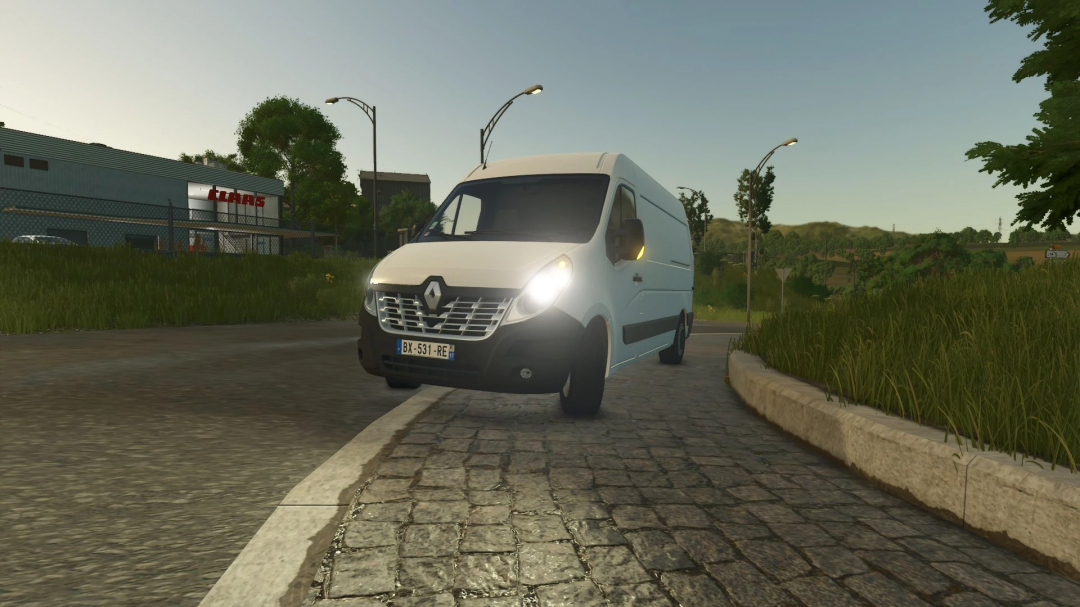 Renault Master III van mod for FS25 parked on a cobblestone road next to a grass field.