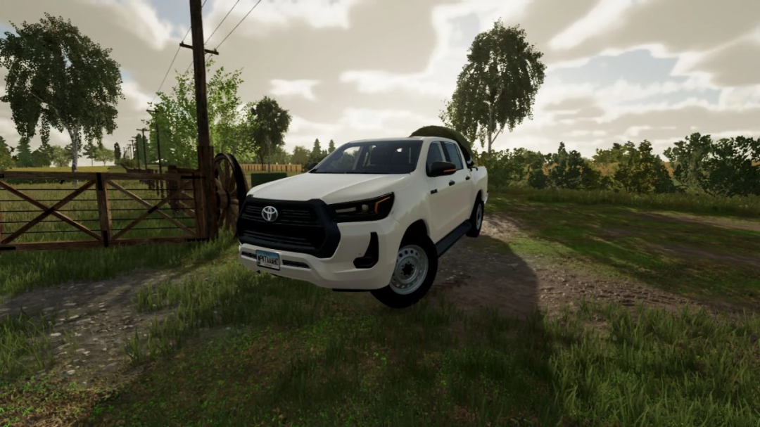 Toyota Hilux 2022 mod in Farming Simulator 22, featuring a white pickup truck on a rural road. FS22 mods.