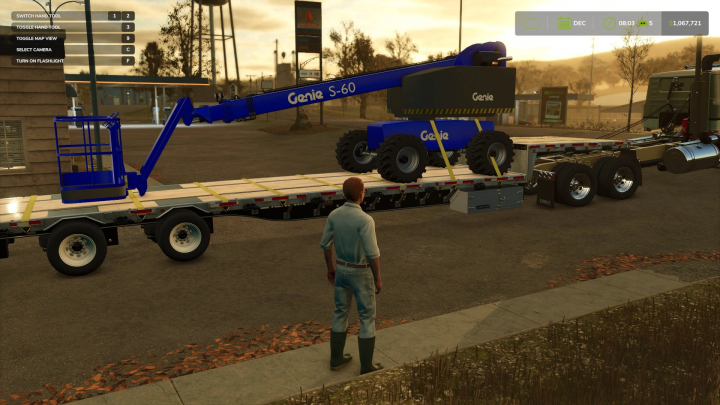 fs25-mods,  Player stands next to a Genie Boom lift on a flatbed trailer in Farming Simulator 25, showcasing FS25 mods.