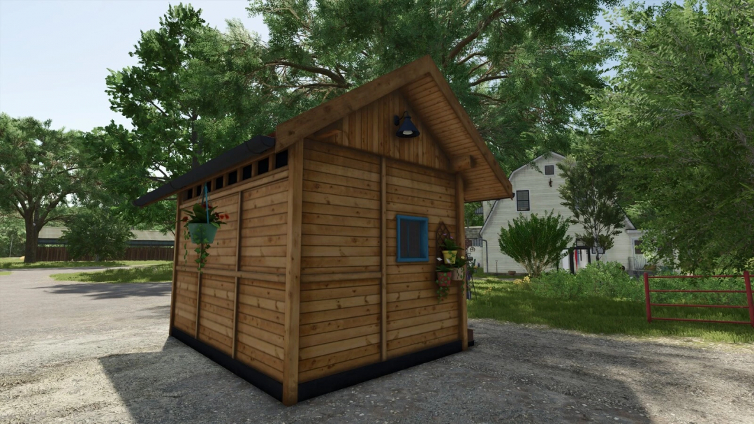 Wooden beehouse mod in Farming Simulator 25 with trees and farmhouse in background.