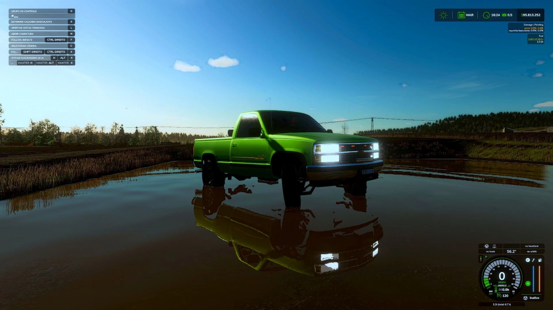 Chevrolet Silverado mod in FS25 driving through a puddle, reflecting on the water under a clear blue sky.