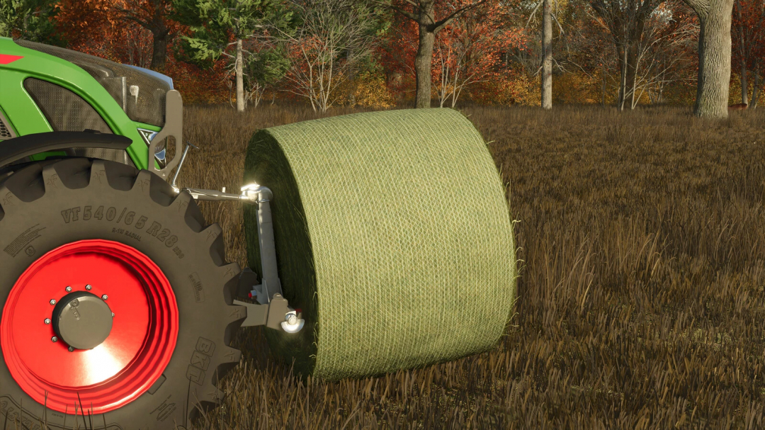 FS25 mod Fliegl Bale Transportcross v1.0.0.0 shown with green hay bale near a tractor wheel in a field.