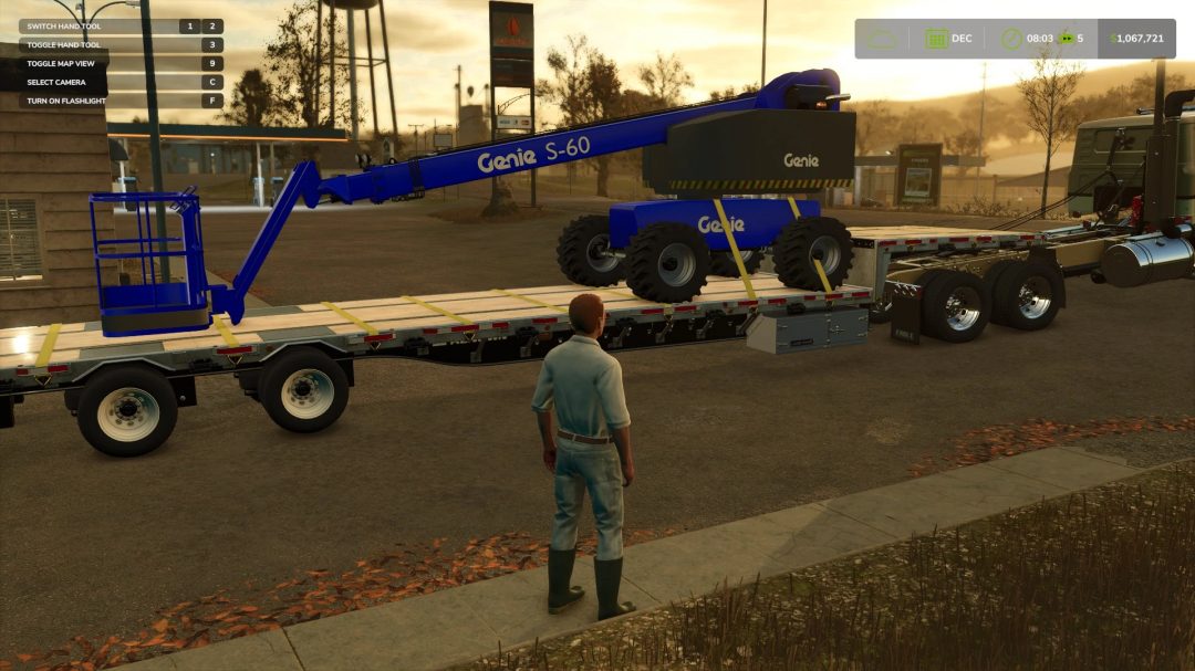 Player stands next to a Genie Boom lift on a flatbed trailer in Farming Simulator 25, showcasing FS25 mods.