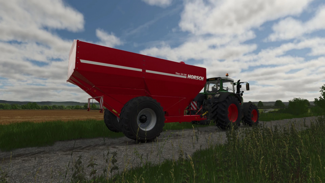 FS25 mod Horsch Titan 34 UW grain cart attached to a tractor on a farm road, clear sky in Farming Simulator 25.