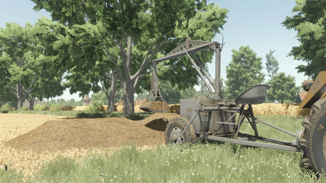 FS25 mod Nujn 100 v1.0.0.0 shows a mechanical arm picking up hay on a farm with trees in the background.