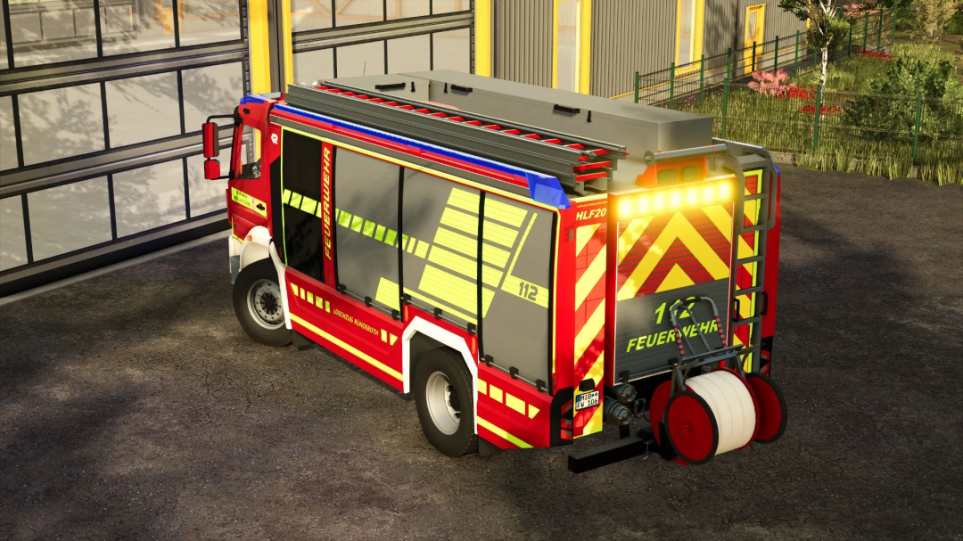 FS25 mod Rosenbauer AT3 Facelift v1.0.0.0, a detailed fire truck parked outside a garage in Farming Simulator 25.