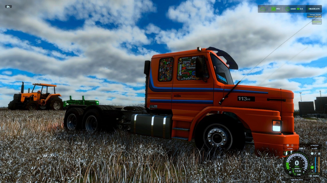 Scania T112 truck mod in FS25, featuring an orange cab with blue stripes, parked in a field with a tractor in the background.