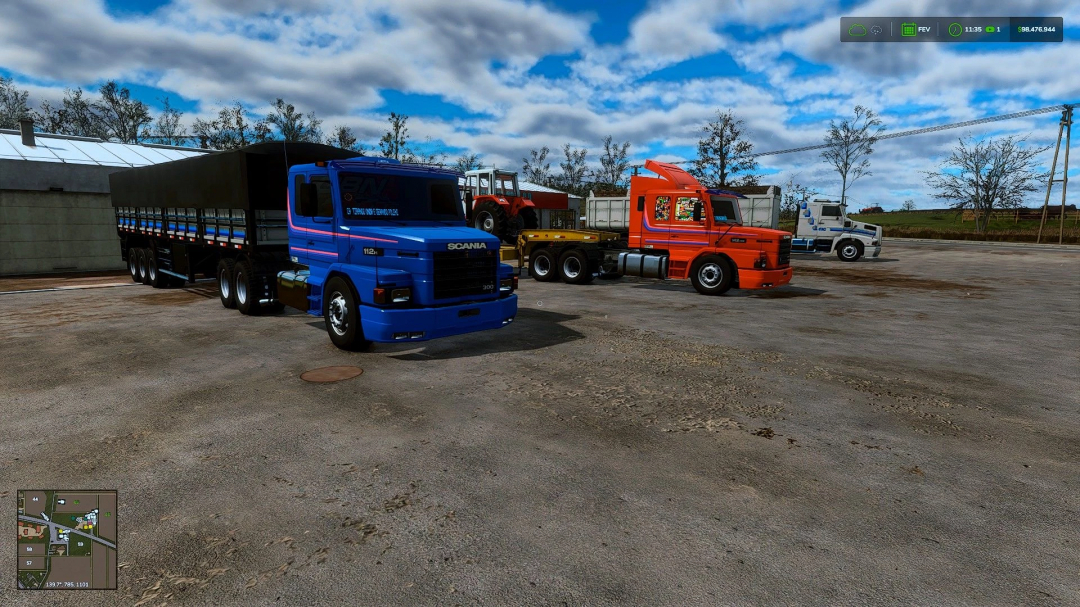 Scania T112 truck in Farming Simulator 25 mod, blue and orange trucks parked on a farm under cloudy sky.