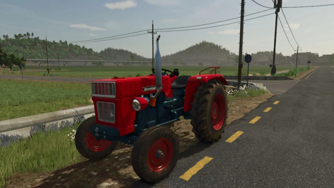 Universal 445 tractor mod for FS25 on a rural road