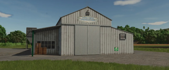 fs25-mods,  FS25 mod Agri Tech Production building in a rural setting, showcasing a large metal structure with a loading zone, enhancing Farming Simulator 25 gameplay.