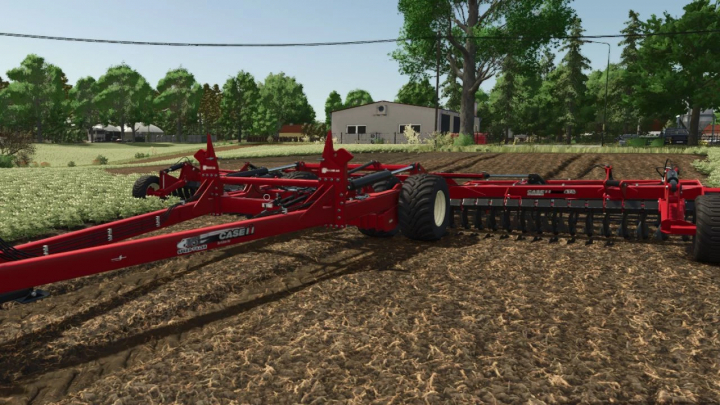 fs25-mods,  Case IH Speed-Tiller 475 mod in FS25, showing red machinery on tilled soil with trees and a building in the background.