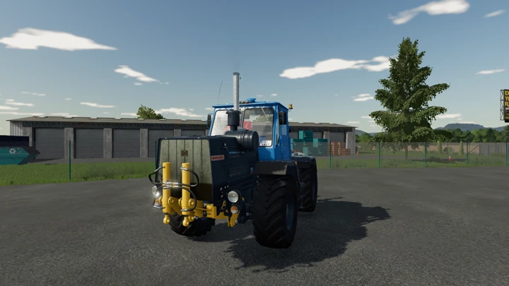 fs22-mods, HTZ T-150K-09 tractor mod in Farming Simulator 22, featuring a blue design parked near a warehouse.