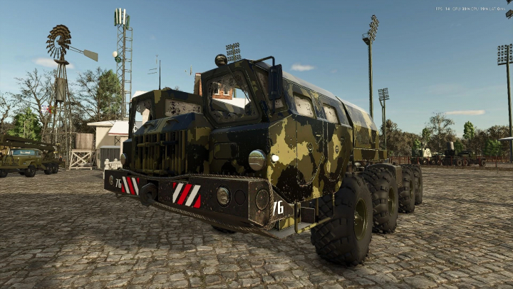 fs25-mods,  Camouflage truck in MAZ MF Pack mod for FS25 on cobblestone street, featuring a windmill and towers in the background.