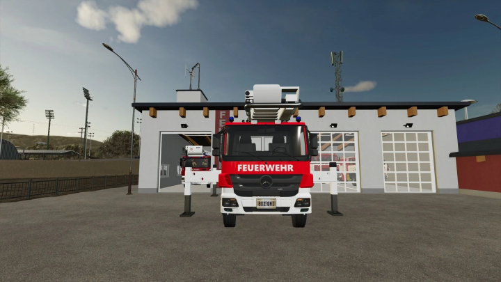 fs25-mods,  Front view of a Mercedes Benz fire truck mod in FS25, parked outside a fire station. Title: Mercedes Benz BF Mittelberg v1.0.0.0.