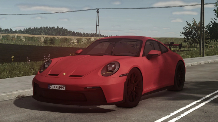 fs25-mods,  Red Porsche Carrera GT3 mod on a road in FS25, showcasing car mods in Farming Simulator 25.