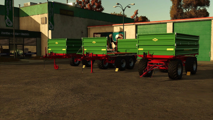 fs25-mods,  Stuutmann trailer pack v1.0.0.0 in FS25 with three green agricultural trailers parked outside a tractor center.