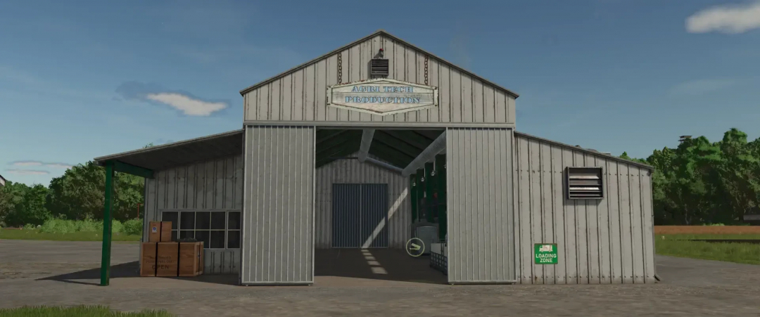 FS25 mod Agri Tech Production v1.0.0.0 showing a large metal barn with open entrance, surrounded by trees.