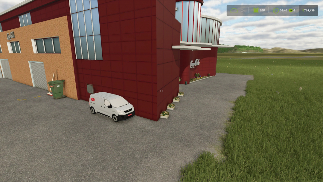 Coca Cola production facility in FS25 mod with red building and white van.