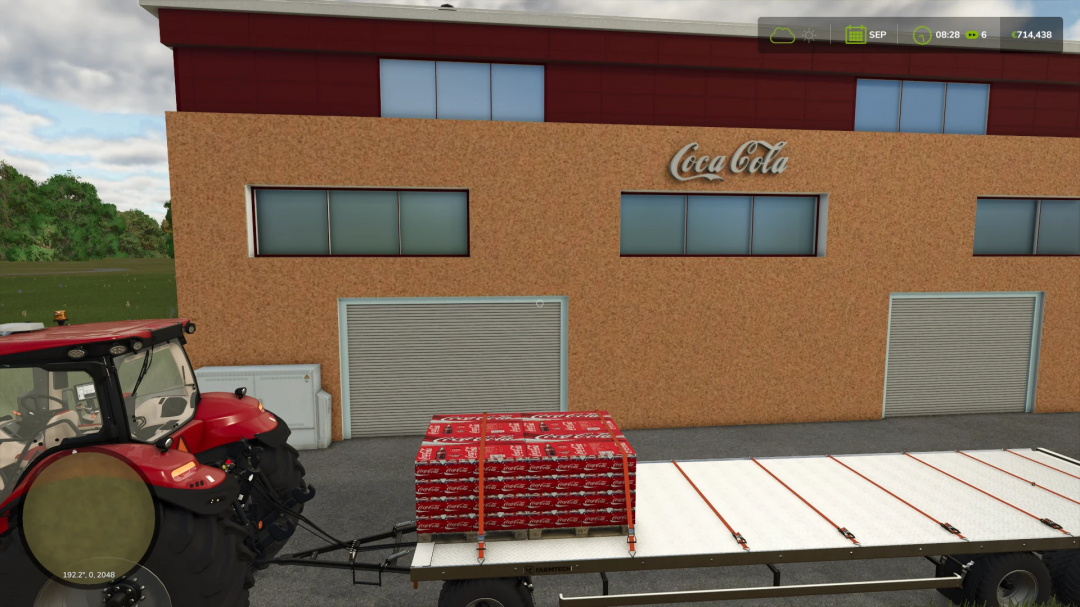 FS25 mod Coca Cola production building with red tractor and trailer carrying Coca Cola pallets.