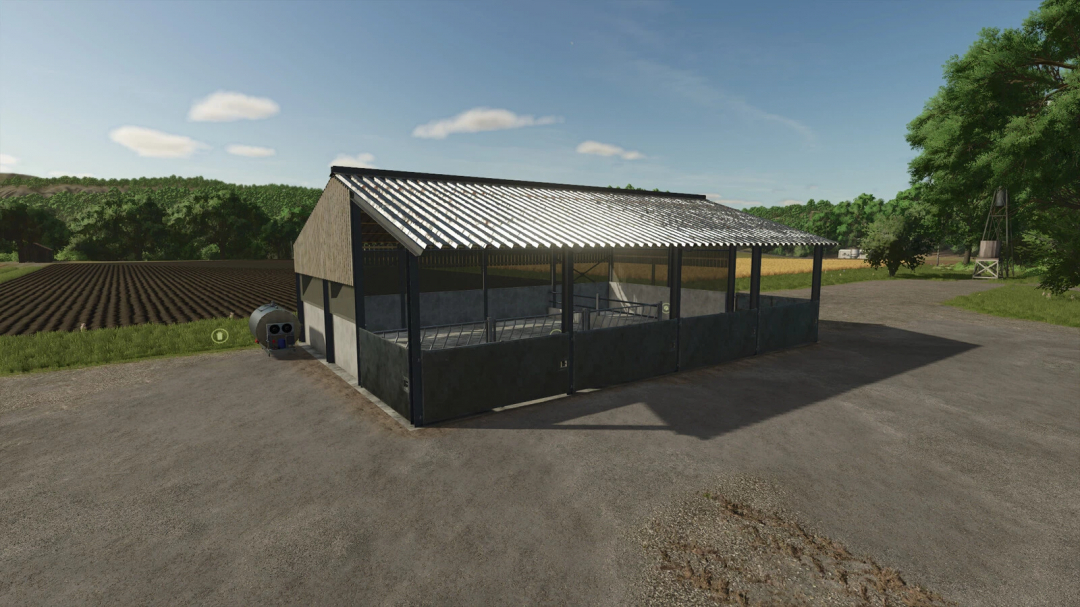 Calf Barn mod in FS25, showcasing a metallic barn structure amidst rural scenery in Farming Simulator 25.