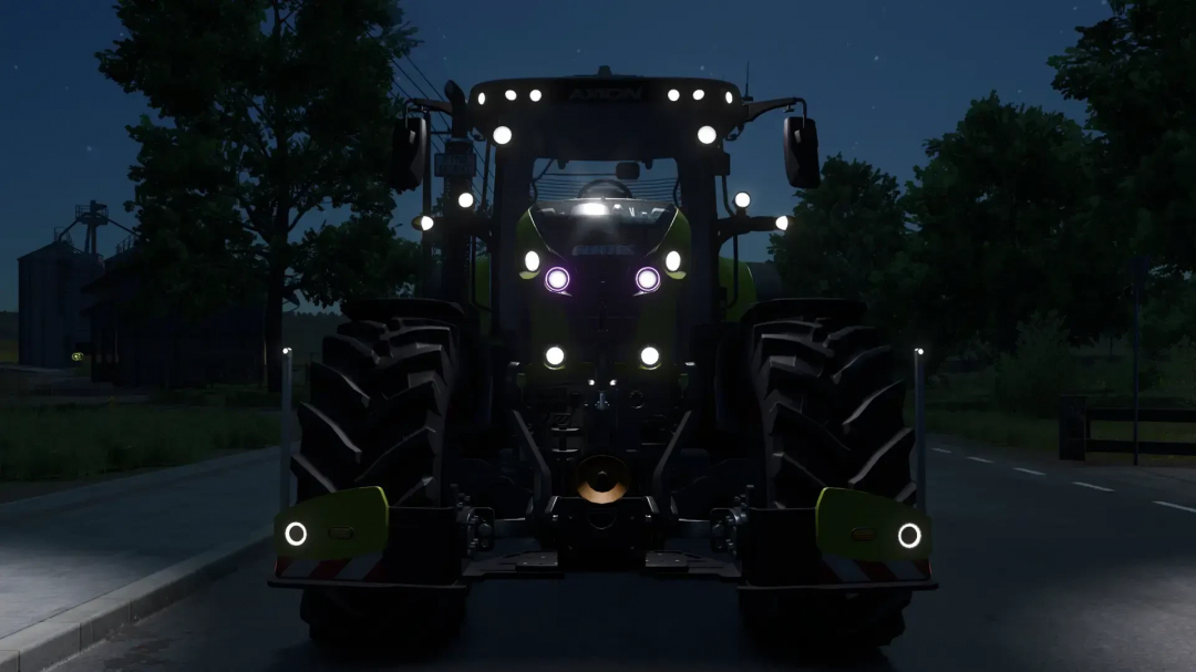 Night view of Claas AXION 870-800 mod in FS25, featuring bright headlights and a rural road setting.