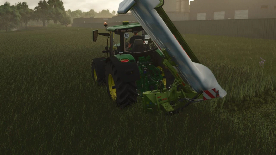 FS25 mod Claas Disco 3900 mowing grass with a tractor on a field in Farming Simulator 25.