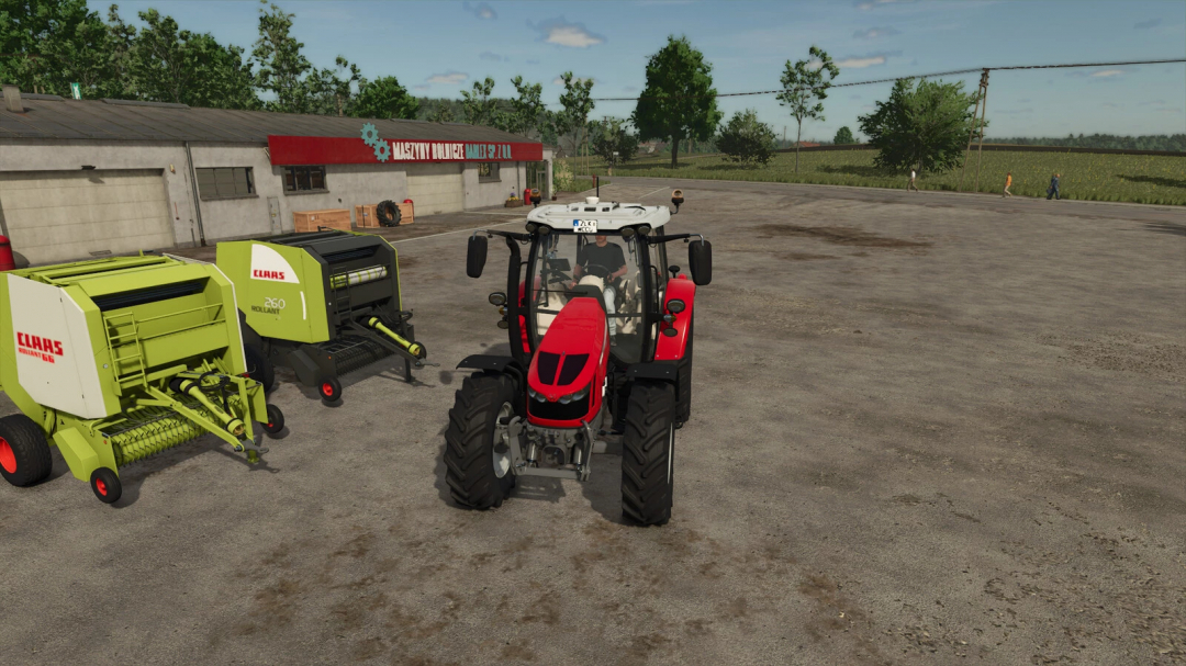 FS25 mods Claas Rollant 66/260 with a red tractor in Farming Simulator 25.